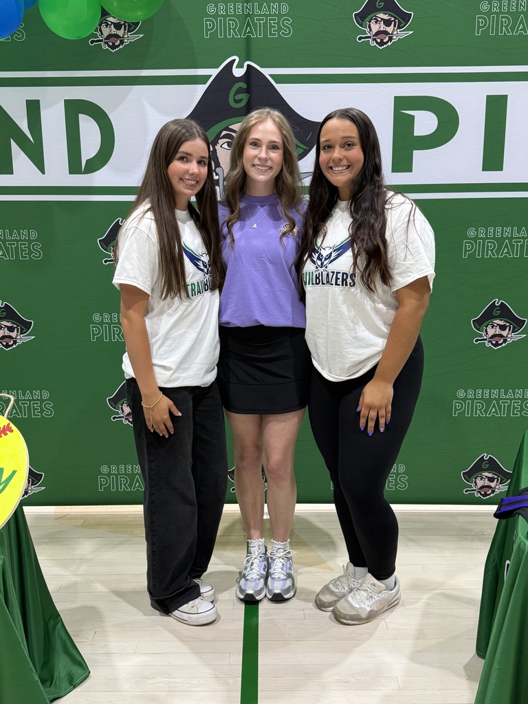 three students in front of a greenland pirate backdrop