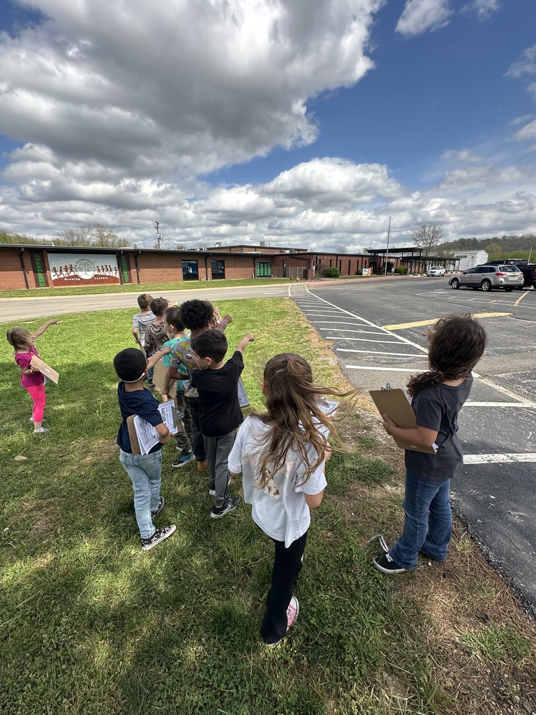 students pointing towards school
