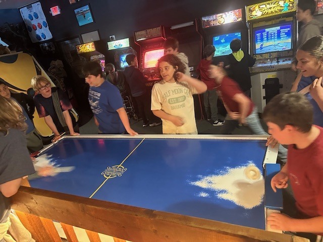 students playing air hockey