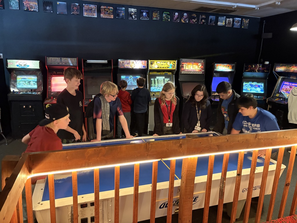 students playing air hockey