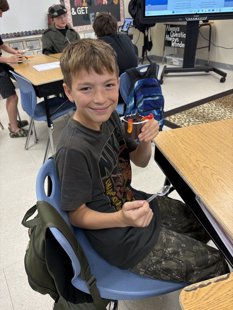 student with gummy worms and pudding