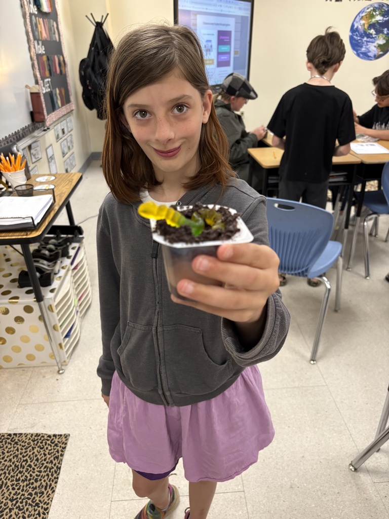 student with gummy worms and pudding