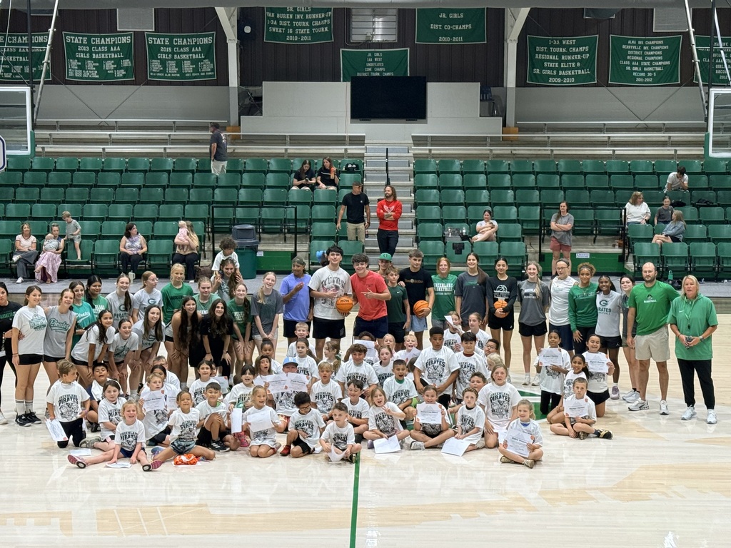 students posing on a basketball court