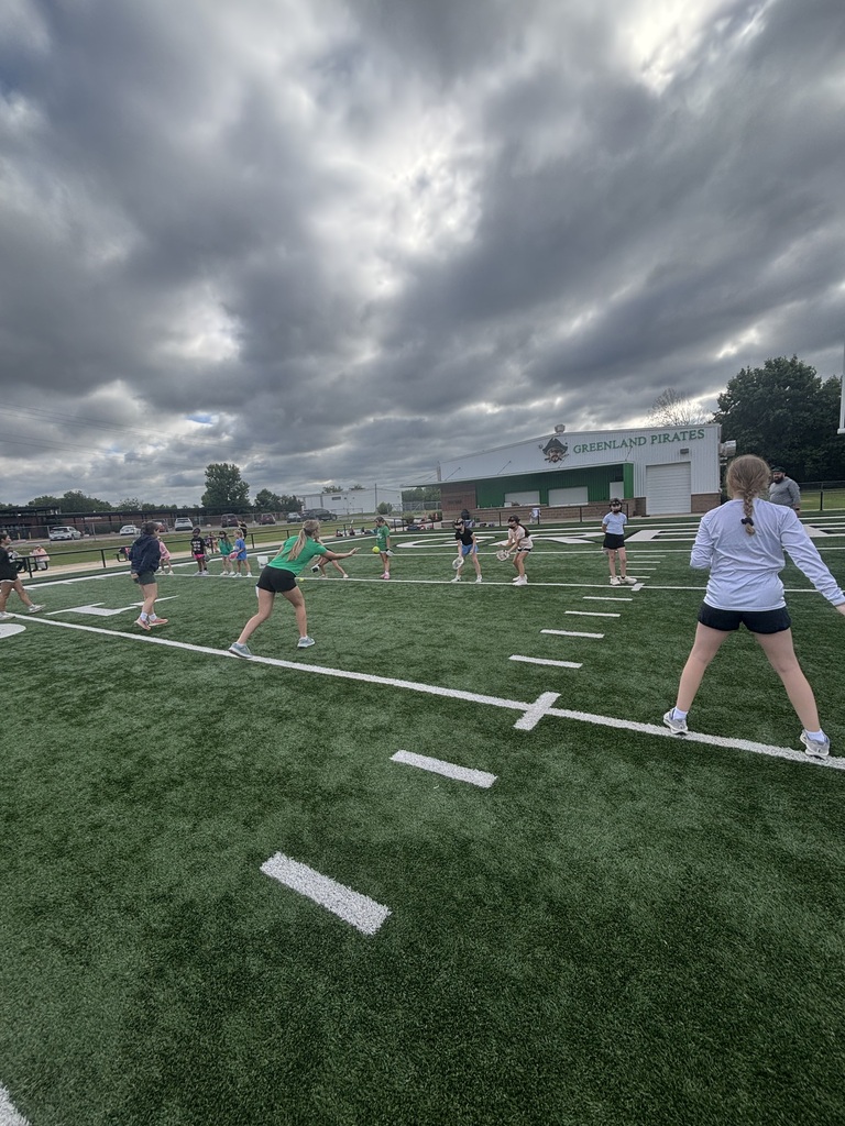 Athletes throwing softballs