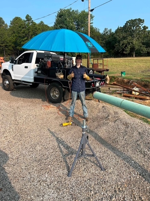 person standing by a truck with an umbrella