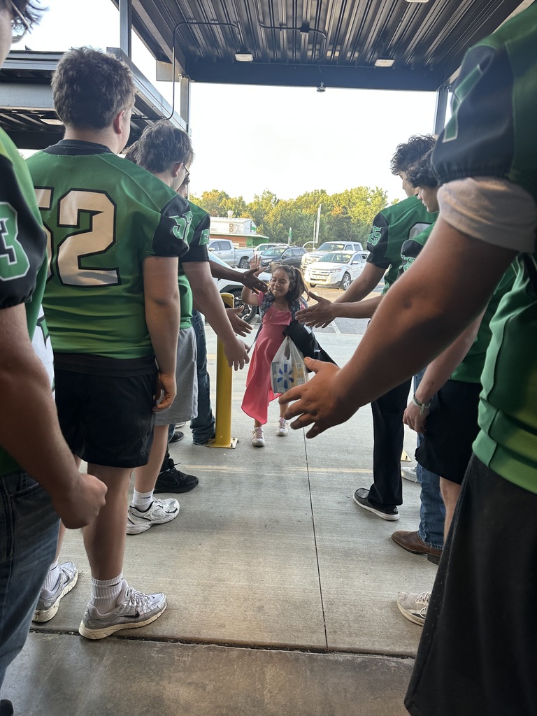 girl high fiving football players