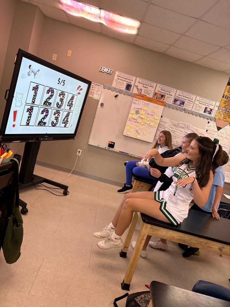 students playing a game in front of a tv