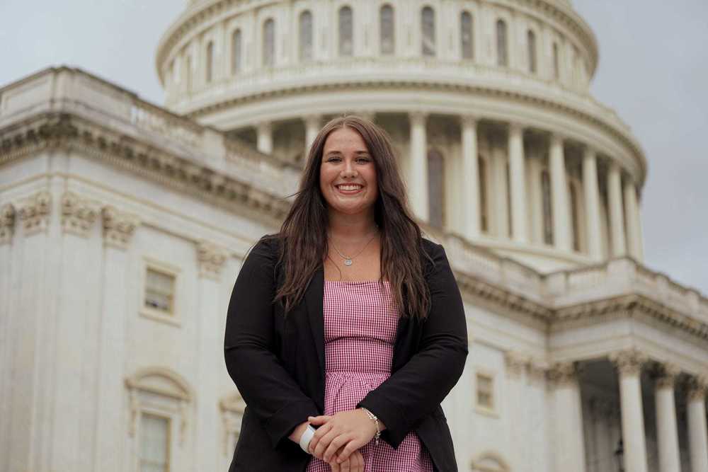 Female standing in front of captial building