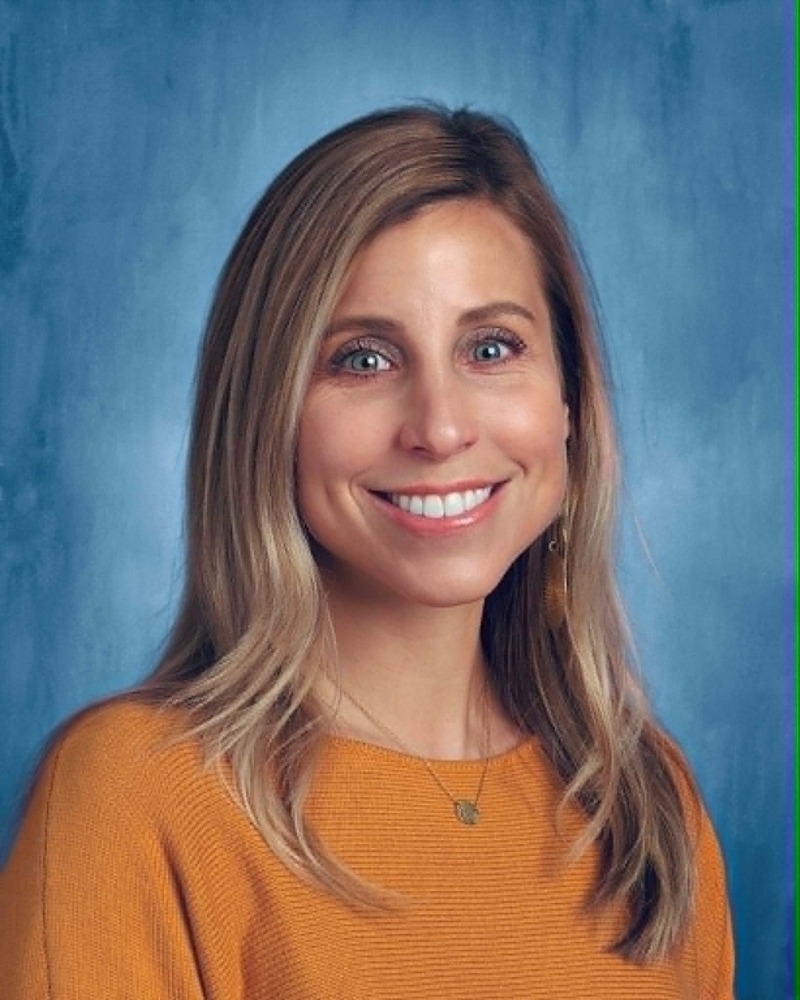 Woman in yellow shirt with blue background