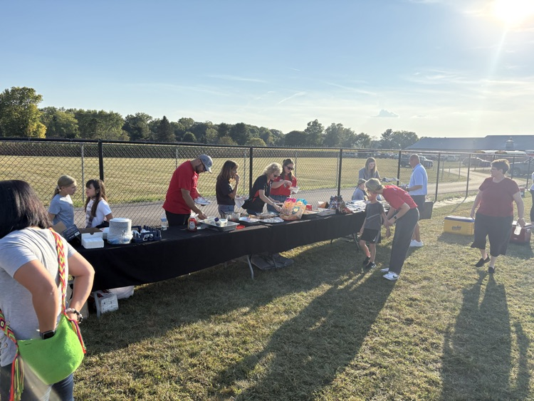 people getting food in tailgate food line