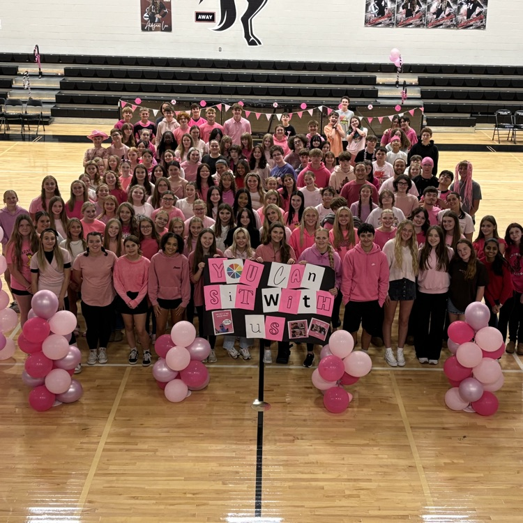 group of students in gym wearing pink