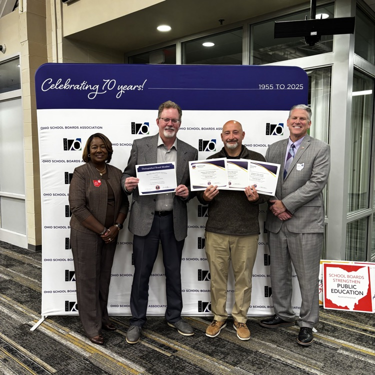 4 people standing with awards