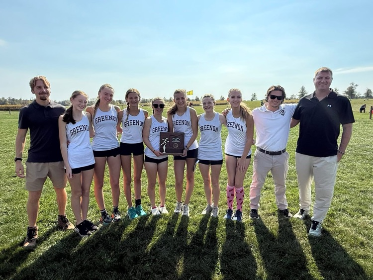 team with white and black uniforms holding trophy
