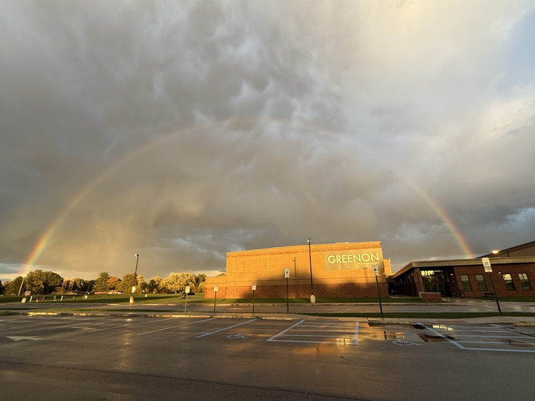 picture of a building with a rainbow over it