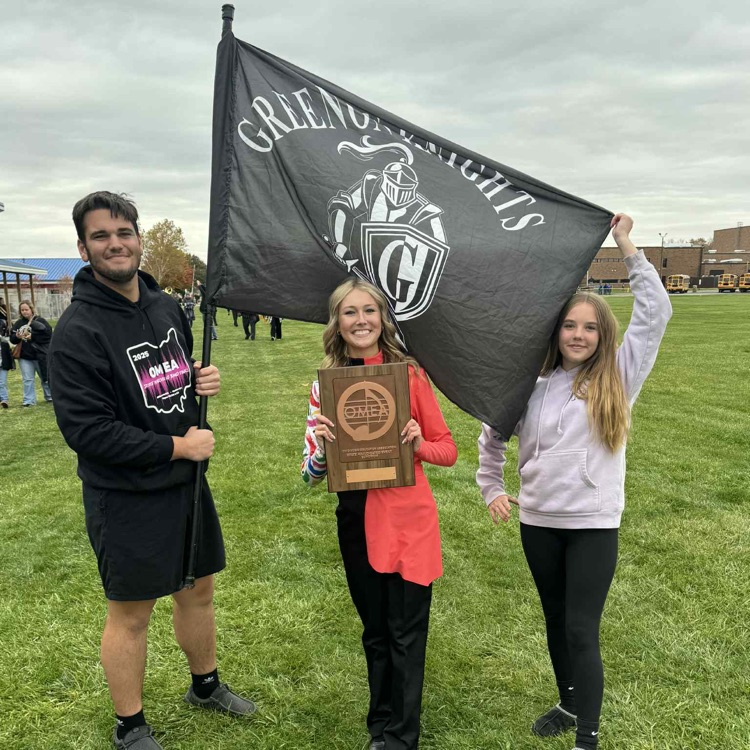 3 band members holding flag