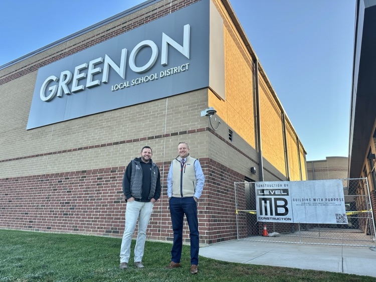 two men standing outside building construction