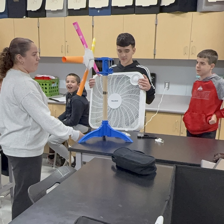 students with fans blowing projects