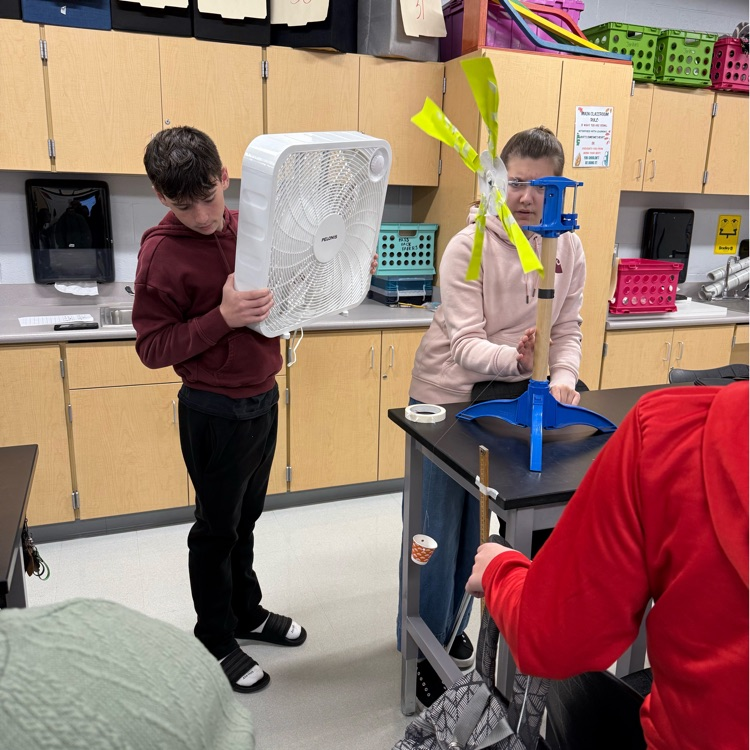 students with fans blowing projects