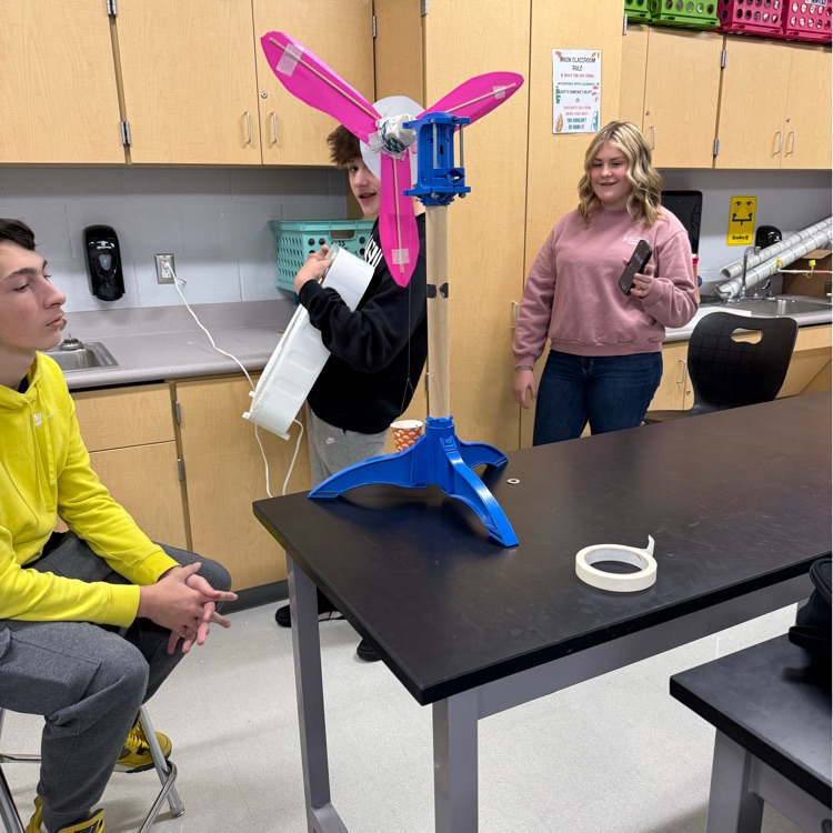 students with fans blowing projects