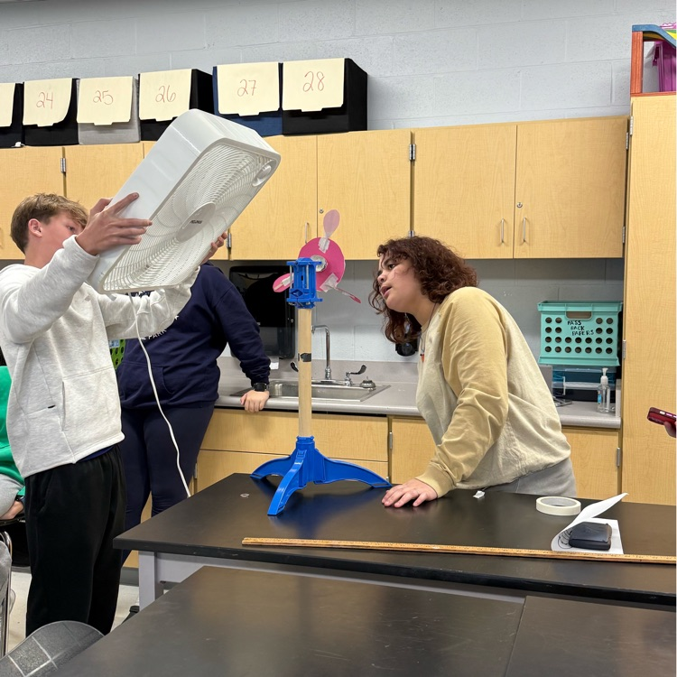 students with fans blowing projects