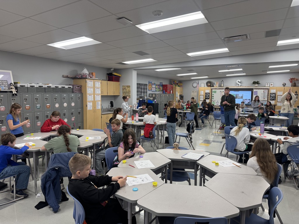 students in a classroom with science experiment