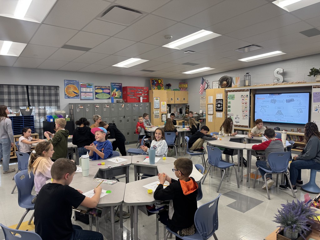 students in a classroom with science experiment