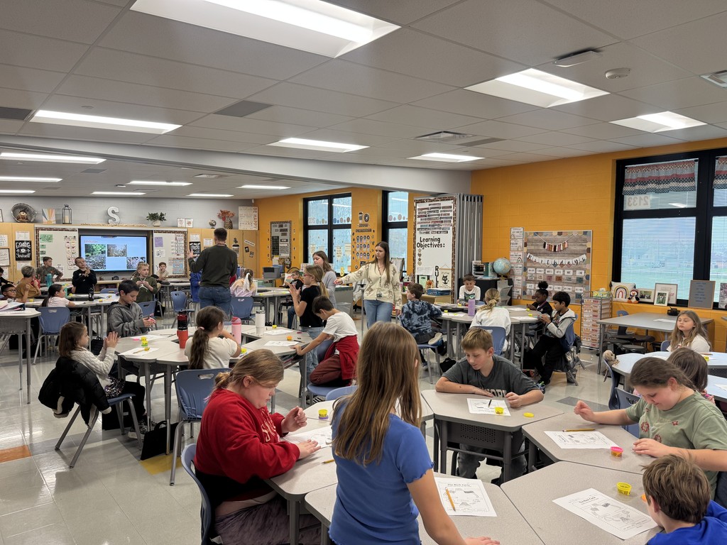 students in a classroom with science experiment