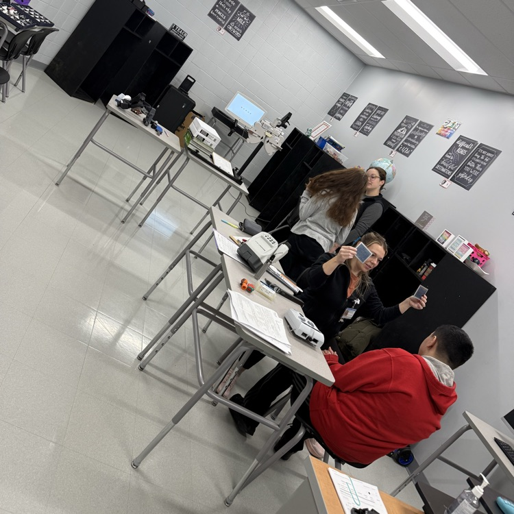 student receiving eye exam in classroom