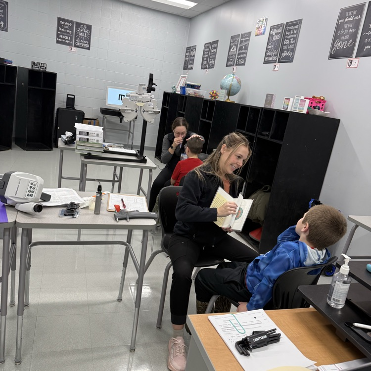 student receiving eye exam in classroom