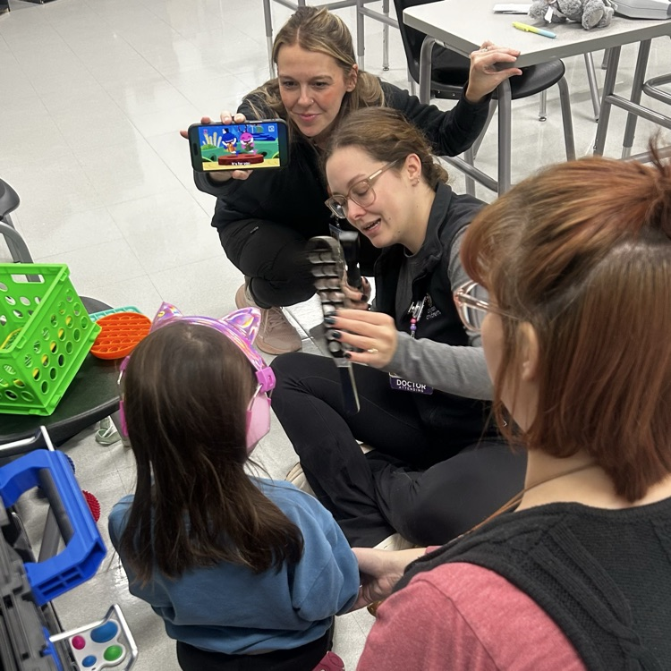 student receiving eye exam in classroom