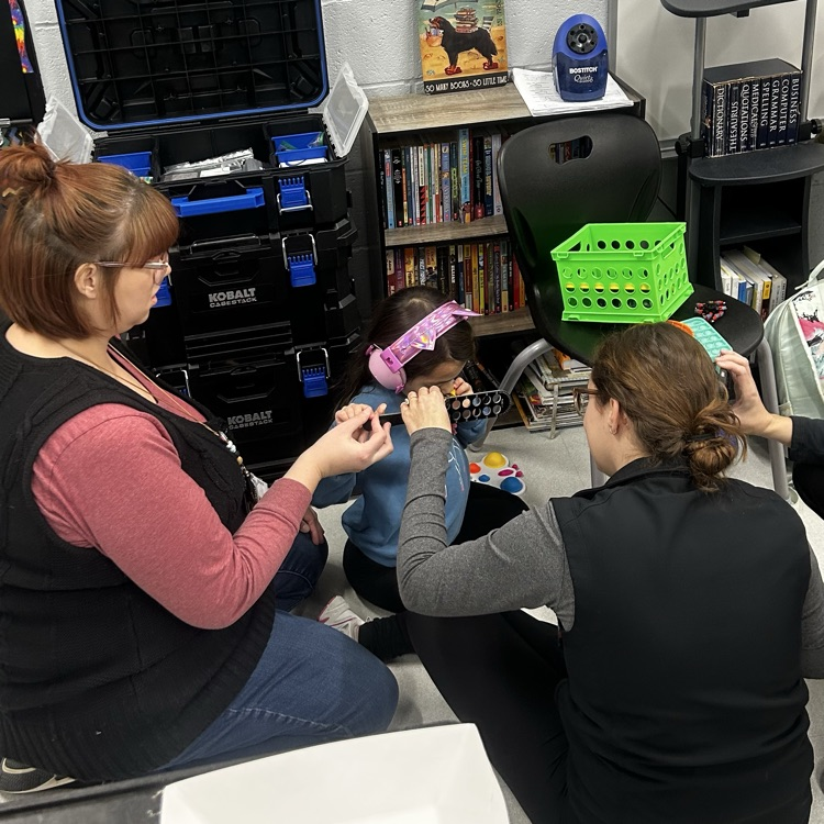 student receiving eye exam in classroom