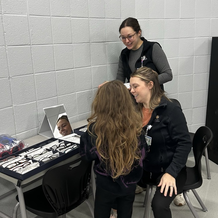 student receiving eye exam in classroom