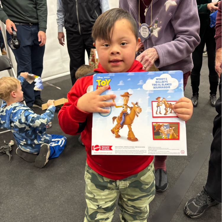 students at Christmas party holding new toy 