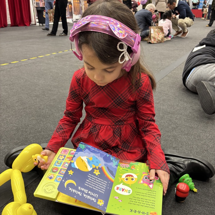 students at Christmas party reading book