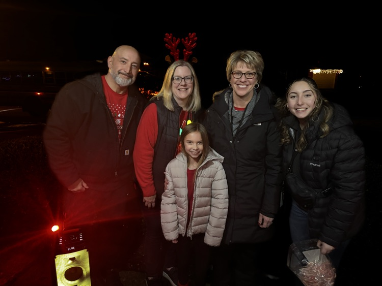 staff standing with student outside 