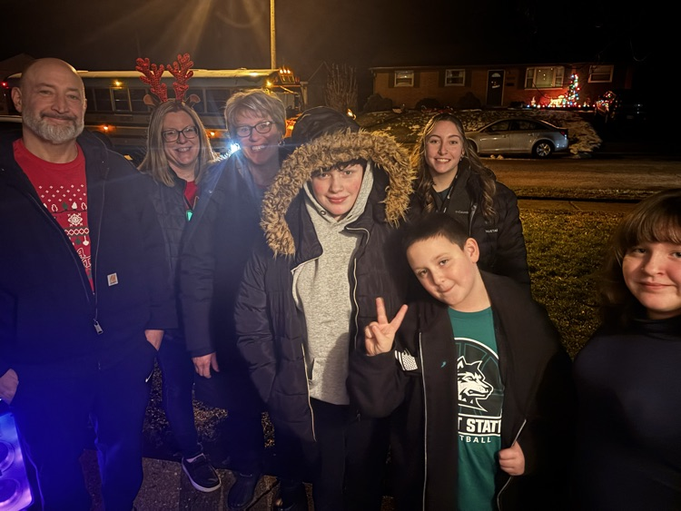 staff standing outside with student 