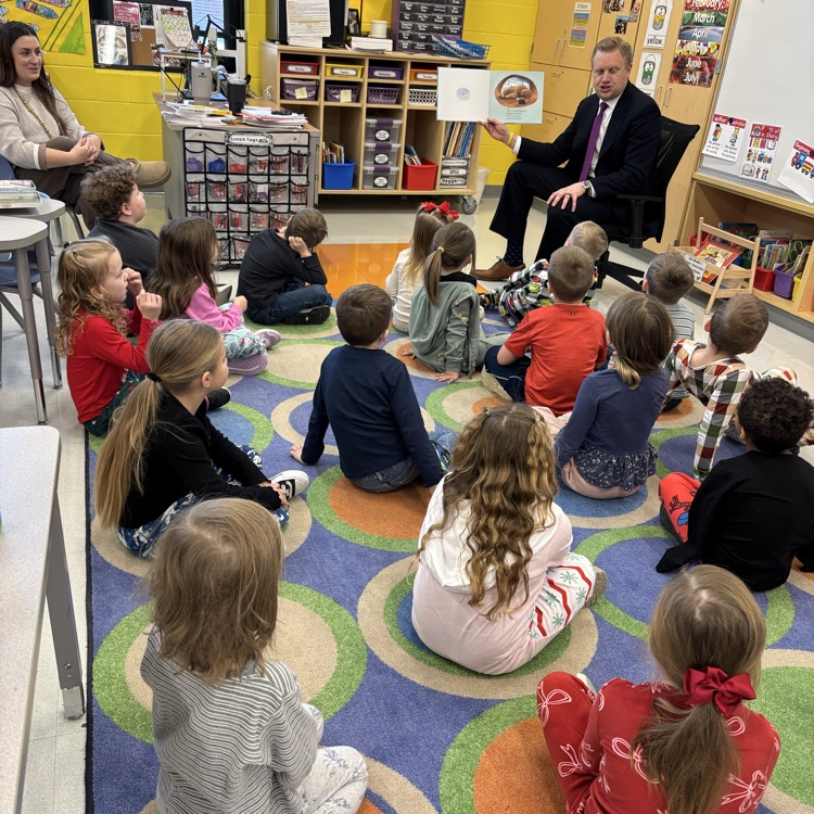 children being read to on a carpet 
