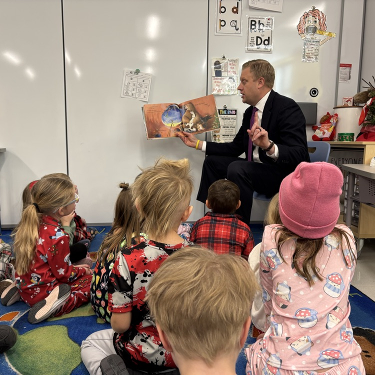 children being read to on a carpet 