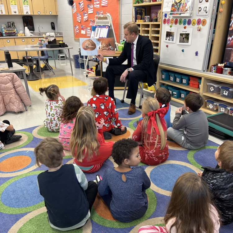 children being read to on a carpet 