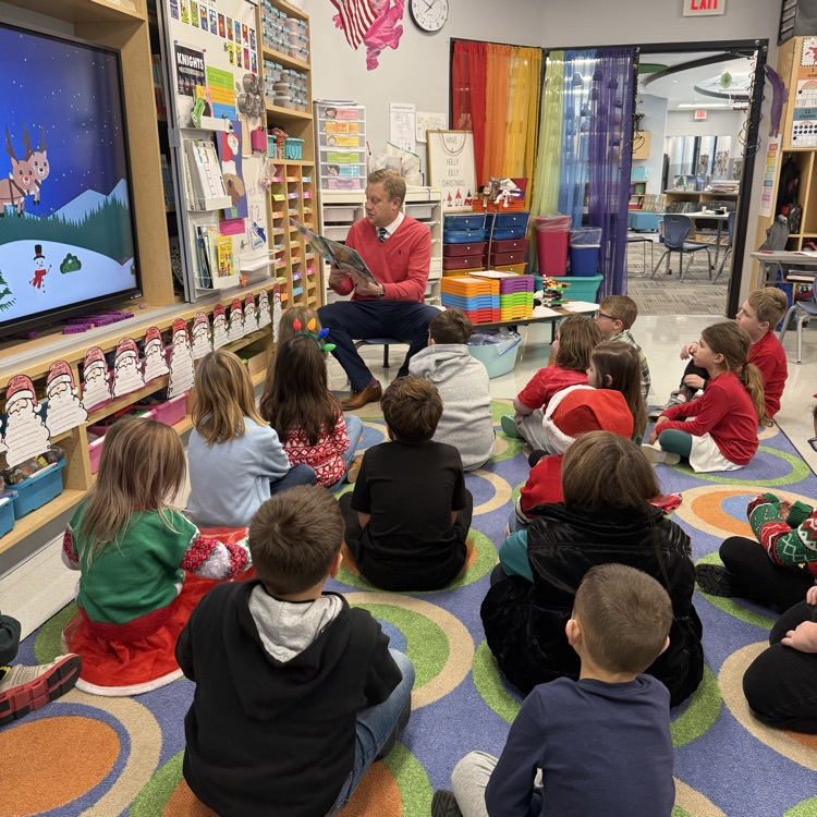 children being read to on a carpet 