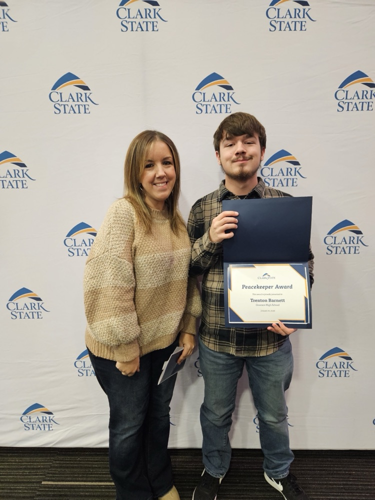 students stranding with his mom with award
