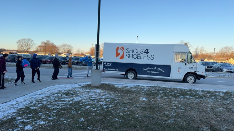 truck with students sitting outside