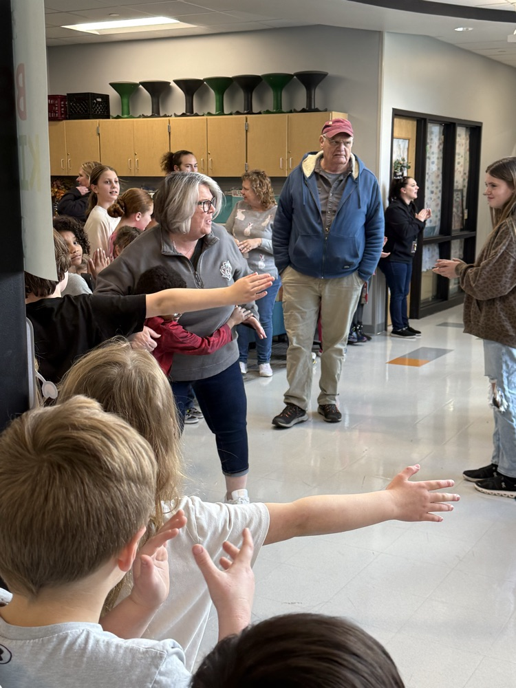 kids clapping in hallway