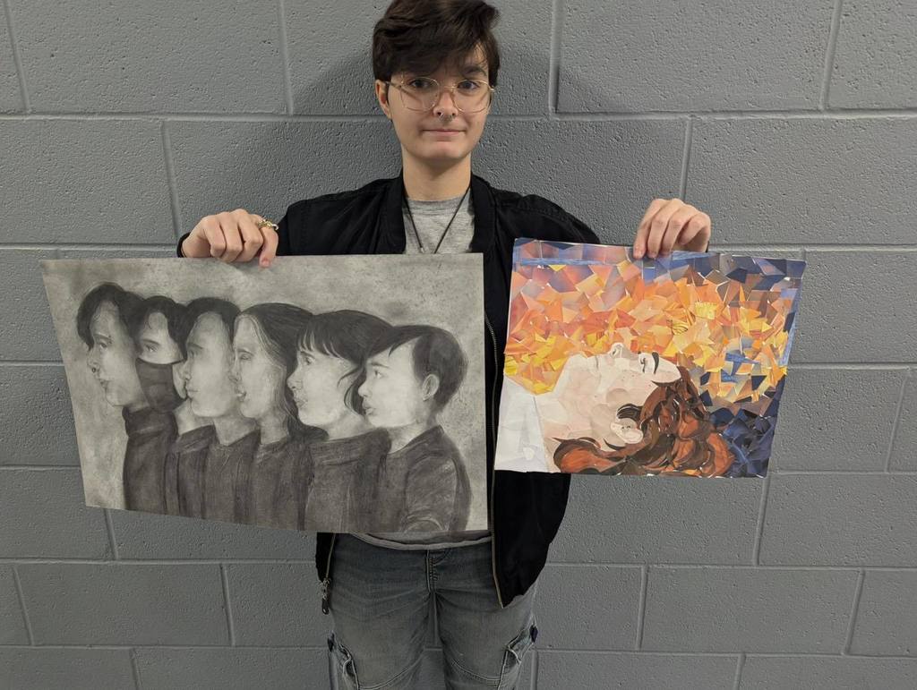 A person holds two artworks: one is a grayscale portrait of five figures, and the other is a colorful abstract painting.