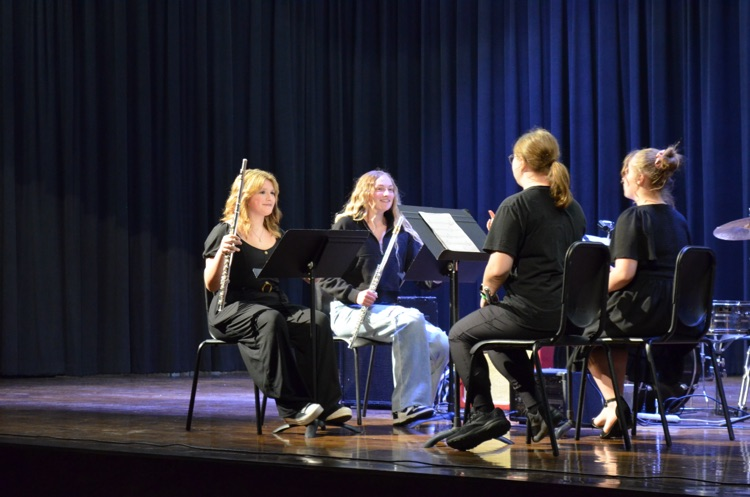 group of 4 playing flutes on stage