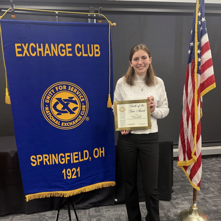 student holding award
