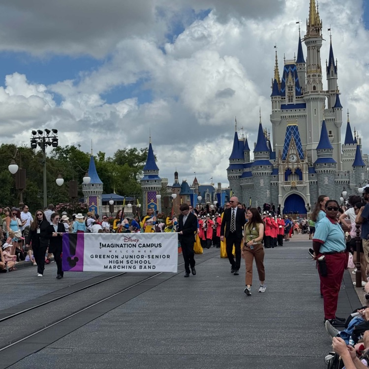 marching band marching in front of castle