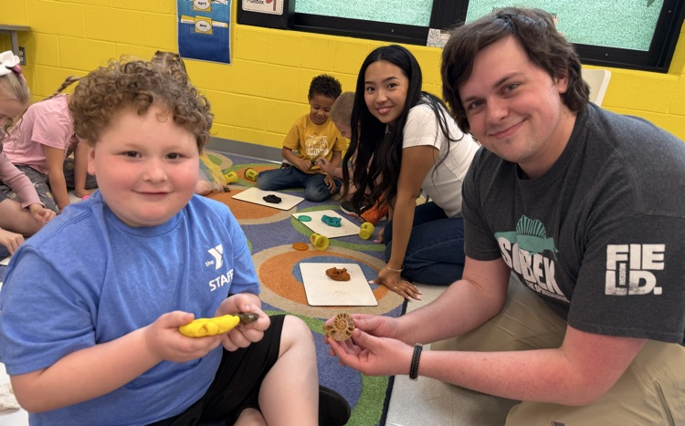 students smiling at camera in classroom 