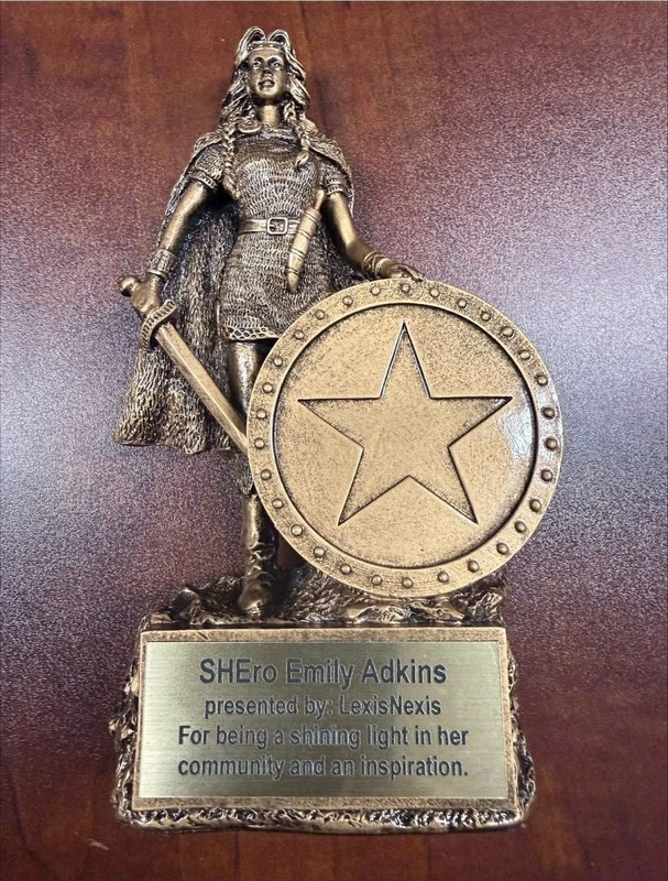 picture of an award that is a woman  holding a shield