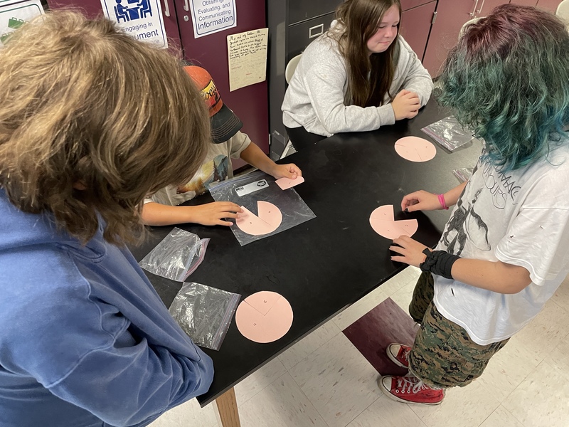 Students participating in broken circles activity
